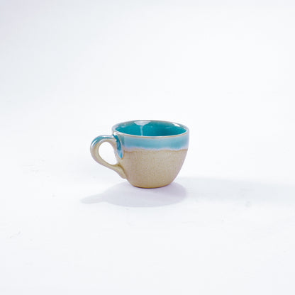 Unsere Keramik Espressotasse in der Farbe türkis aus Steinzeug-Keramik, mit einer Kapazität von 60 Milliliter, einem Durchmesser von 6,5 Zentimeter und einer Höhe von 5 Zentimeter. Aus unserer nachhaltigen Töpferei selbst getöpfert und mit handaufgetragener Glasur gebrannt.  