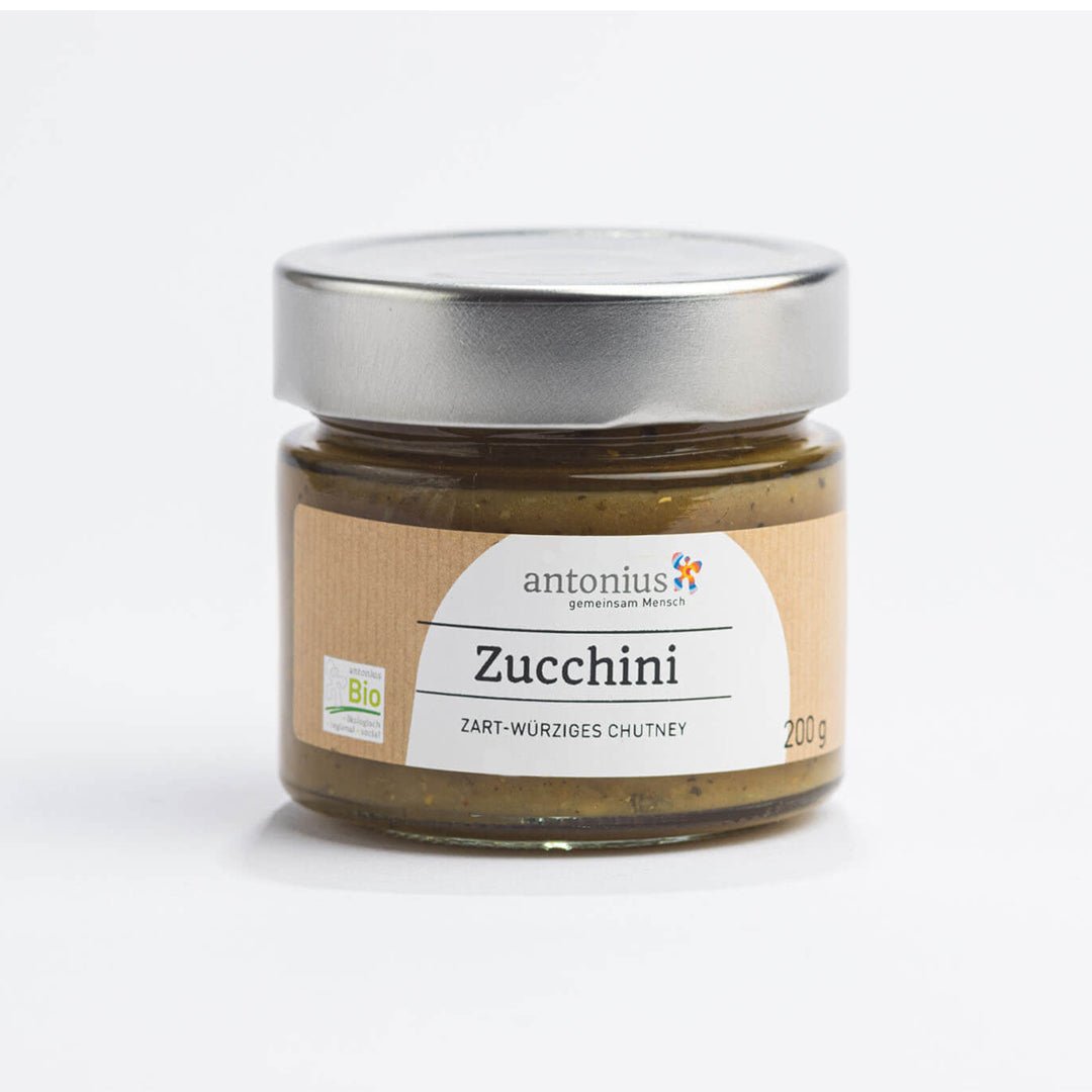 Ein mit einem Metalldeckel verschlossenes Glas mit Zucchini-Chutney und der Aufschrift &quot;Zucchini - zart-würziges Chutney&quot;.